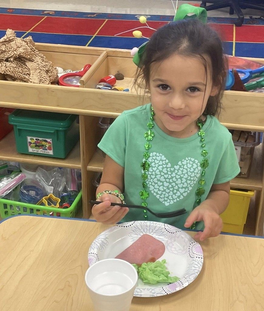 A girl eating green eggs and ham