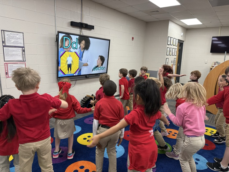 kindergarten class working out to community helpers