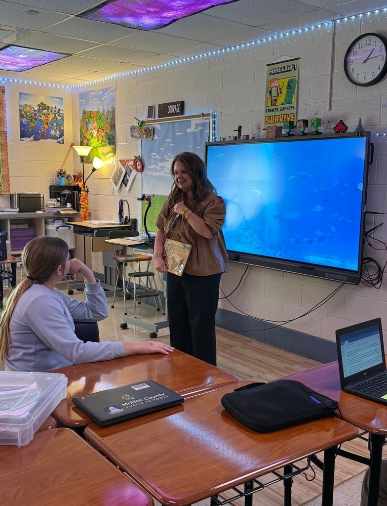 Ms. McAnally reading to a class.