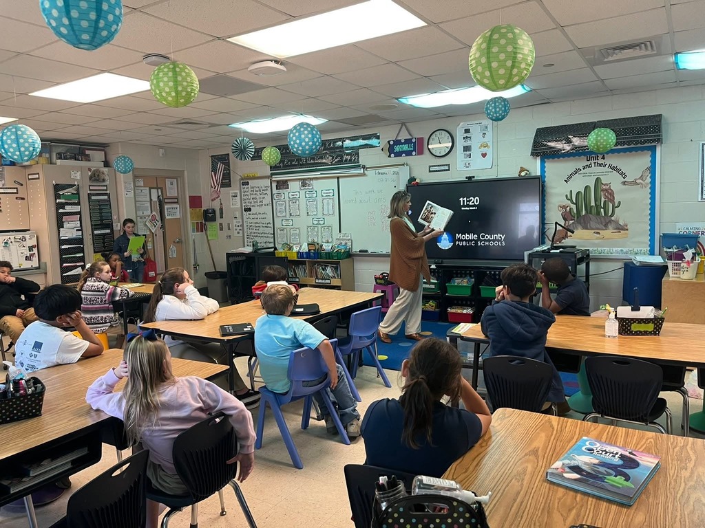 Mrs. Culbreth reading to a class.