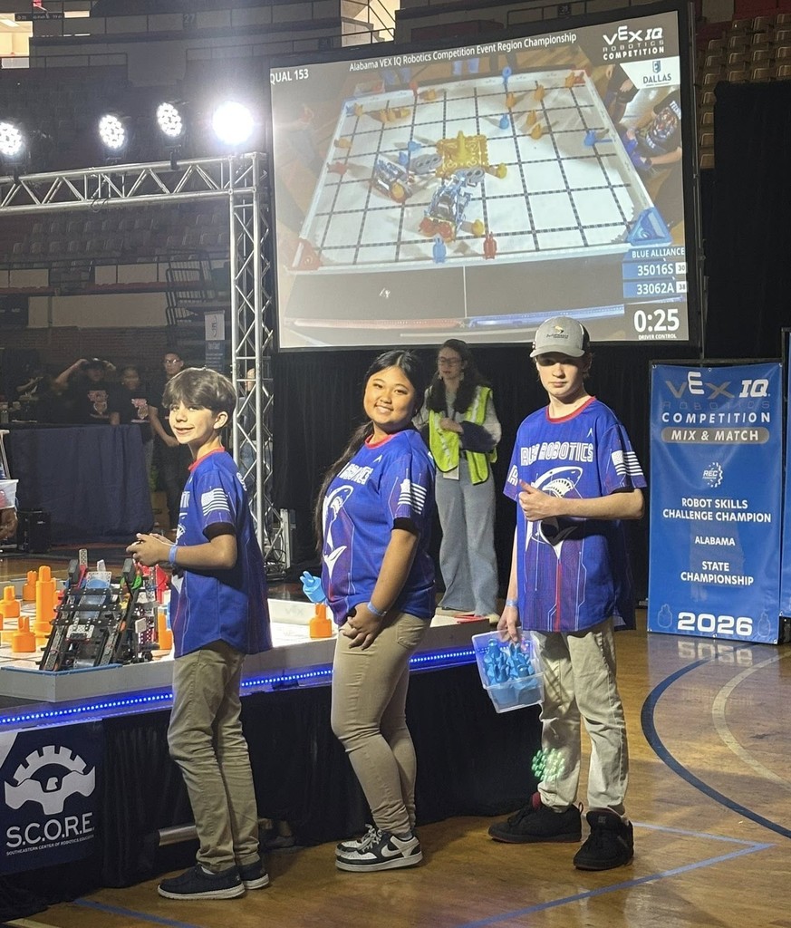 Three Alba Middle students at a robotics tournament