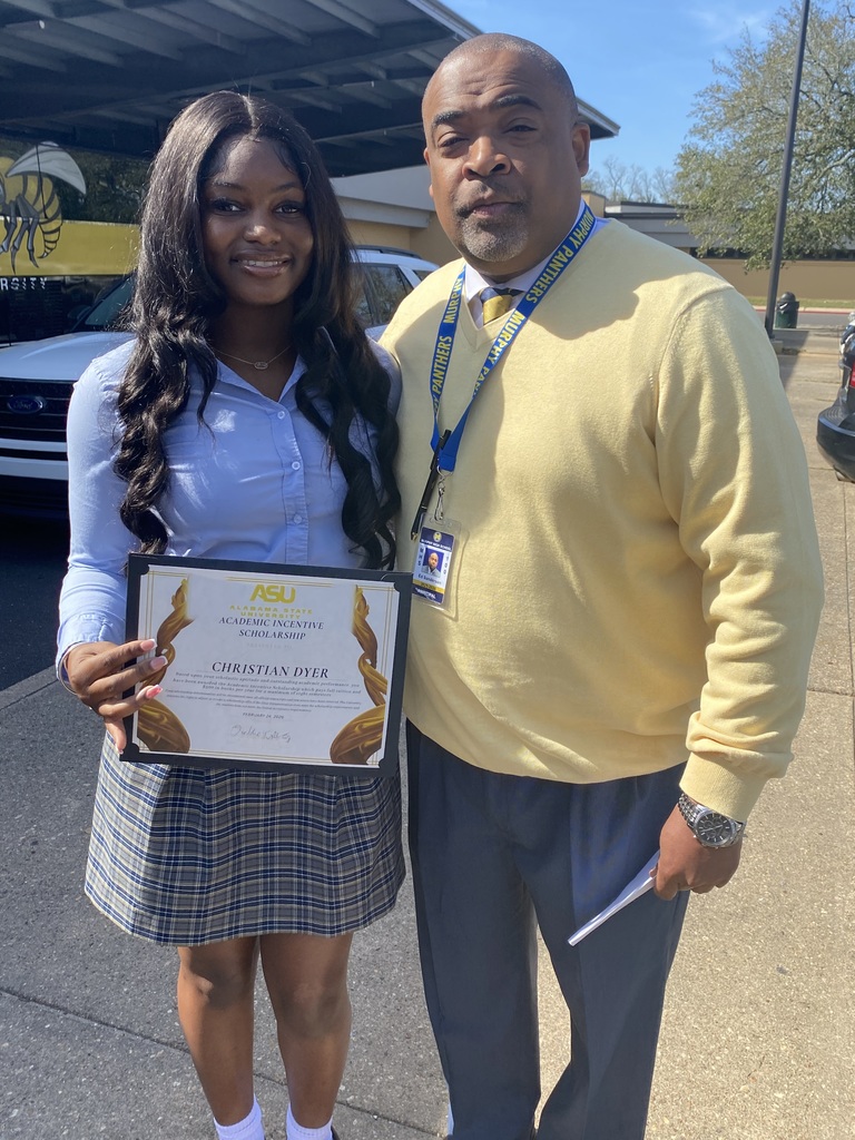 Murphy's principal stands with a student holding a certificate