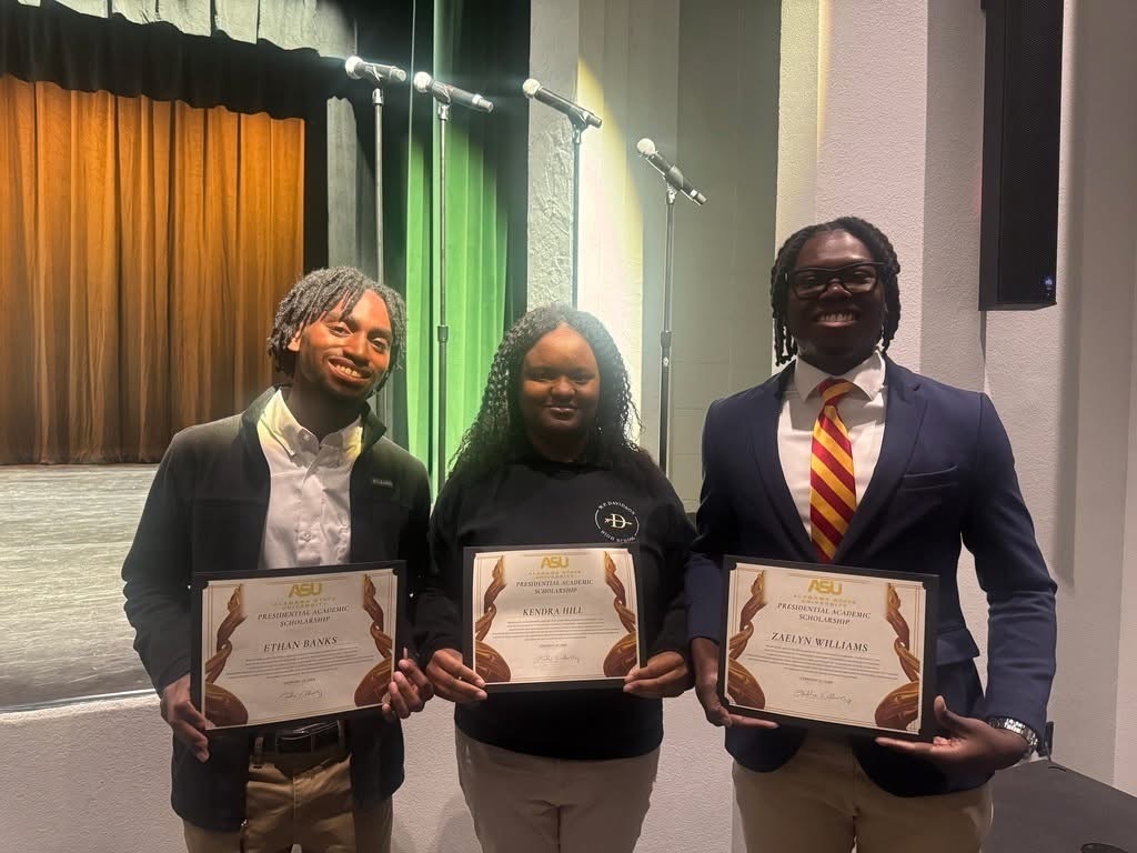 Three Davidson students holding certificates