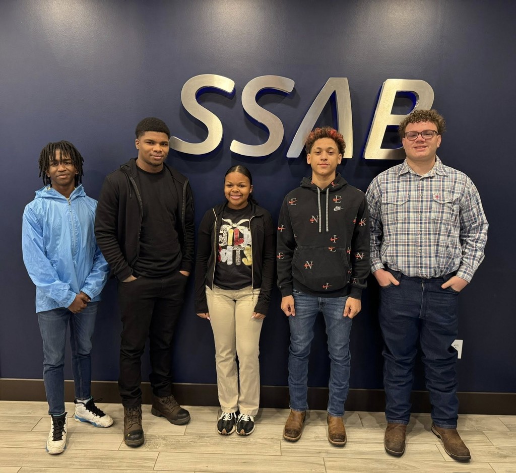 Five Citronelle High students standing in front of a wall with the SSAB logo