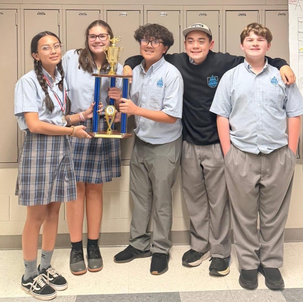 Five Barton Academy students holding a trophy