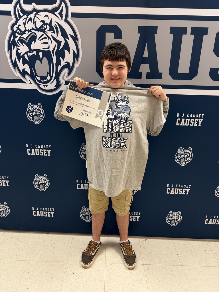 Student holding t-shirt and certificate