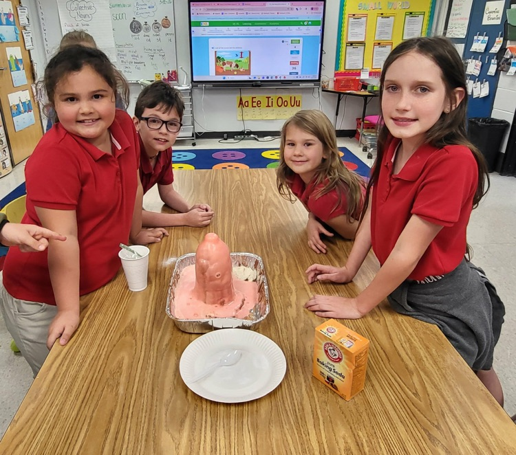 second graders in Mrs. Caballero’s class creating volcanoes to see quick land changes. 