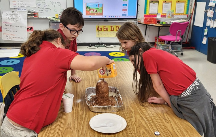 second graders in Mrs. Caballero’s class creating volcanoes to see quick land changes. 