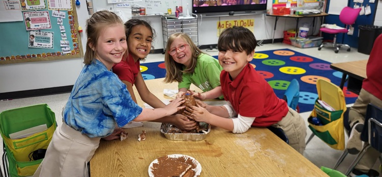 second graders in Mrs. Caballero’s class creating volcanoes to see quick land changes. 