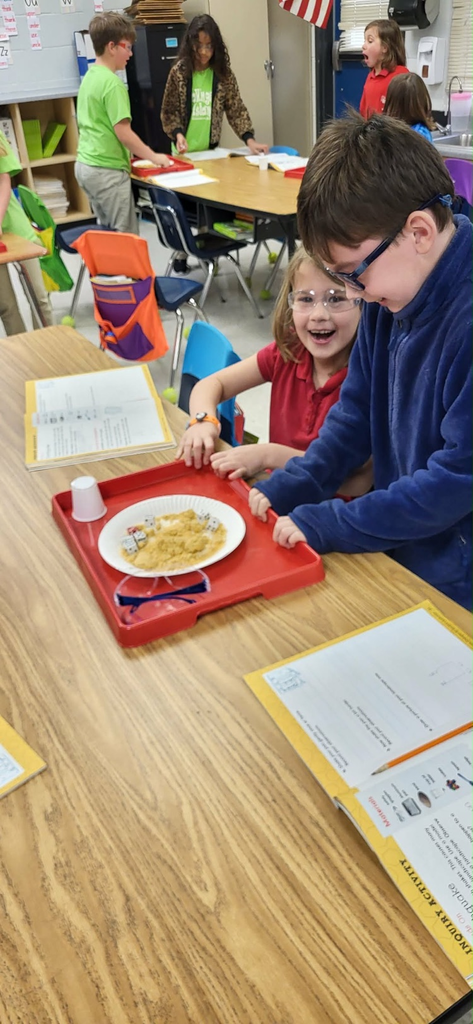second graders in Mrs. Caballero’s class creating earthquakes to see quick land changes. 