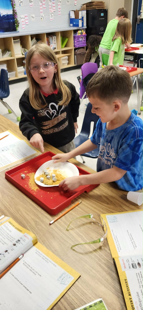 second graders in Mrs. Caballero’s class creating earthquakes to see quick land changes. 