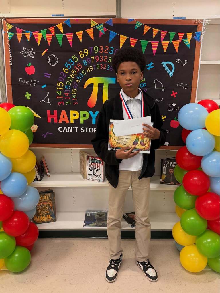 A Scarborough Middle School student holding a certificate