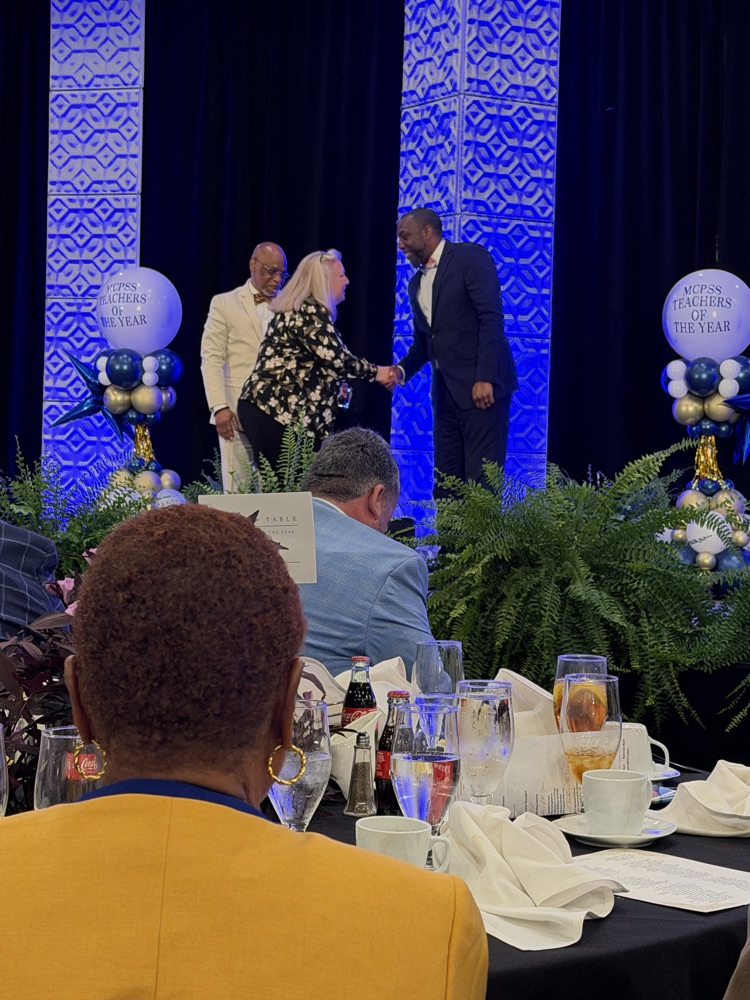 Angela shaking hands with presenter 