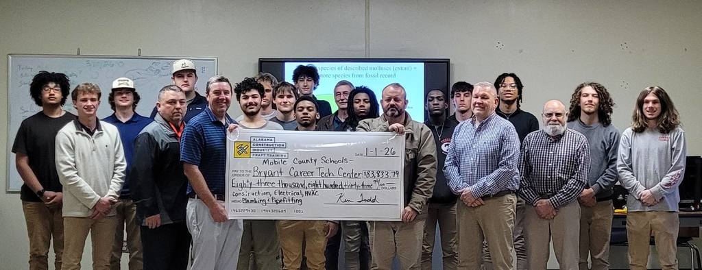 A group of Bryant Career Technical Center students and instructors, holding an oversized check
