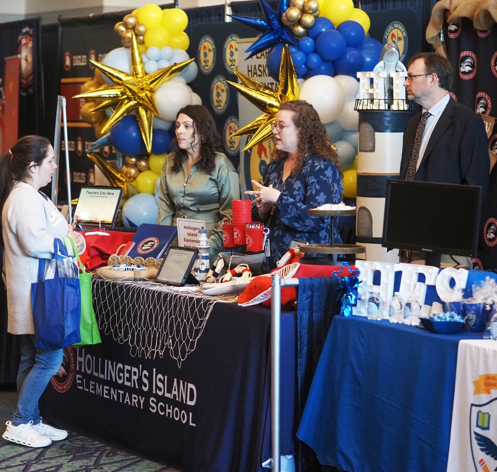 A job-seeker speaking with three representatives of Hollinger's Island Elementary