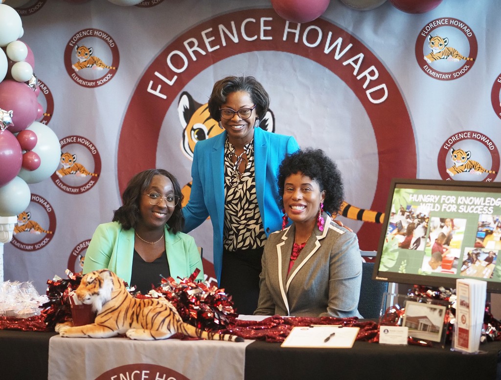 The principal and two other representatives of Florence Howard Elementary at their booth