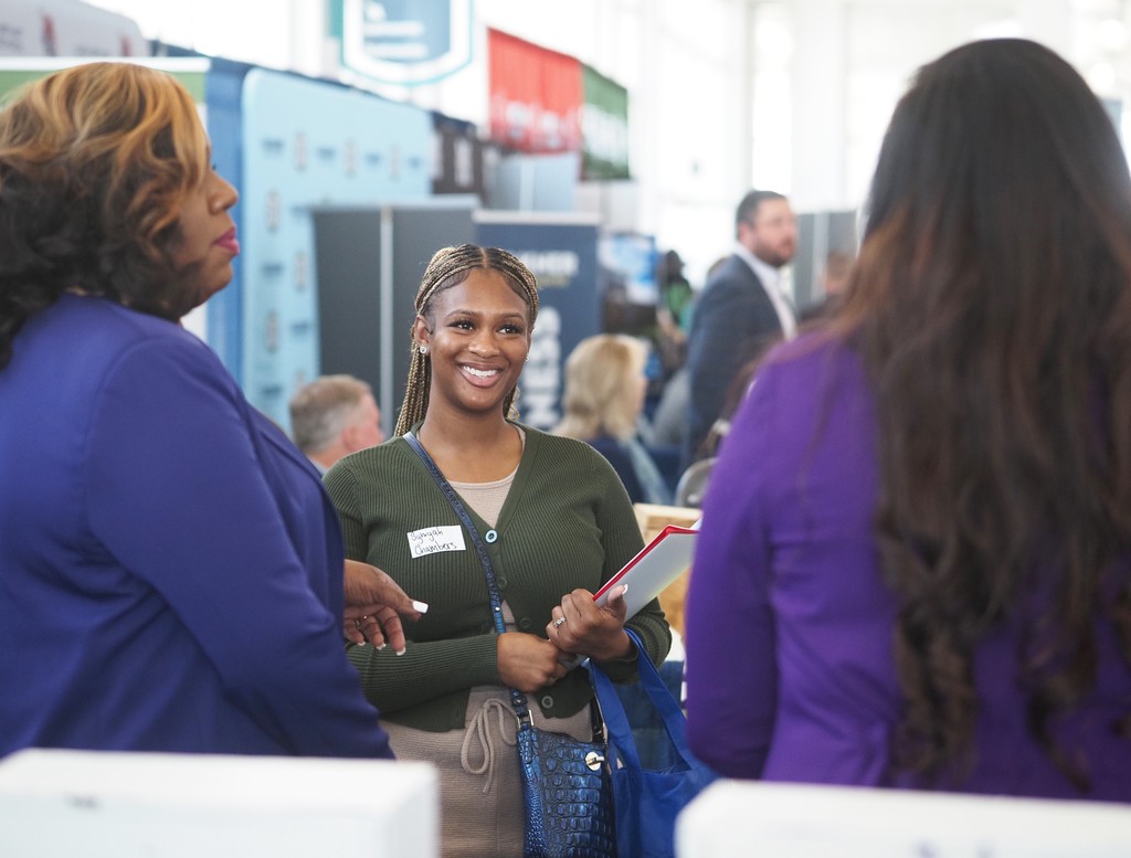 A job-seeker talking with two representatives of Blount High School