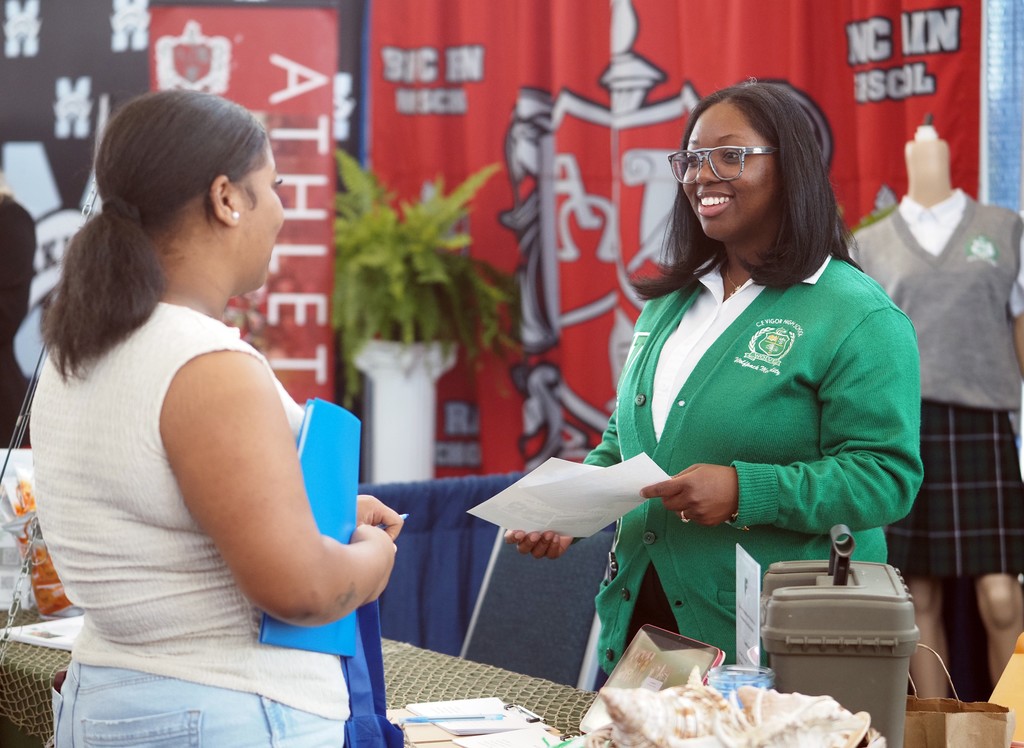 A job-seeker talking with a representative of Vigor High School