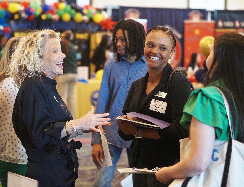 E.R. Dickson's principal talking with two job-seekers