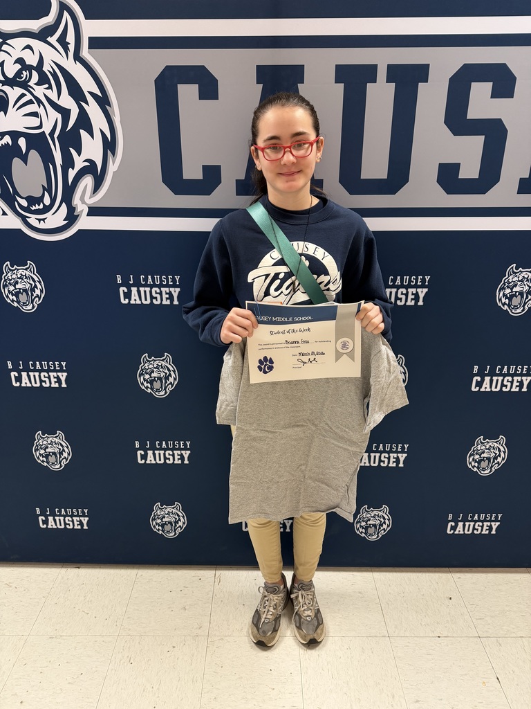 Student holding t-shirt and certificate