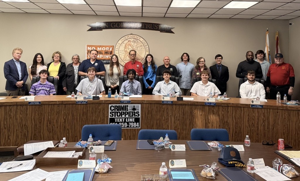 A group of Alma Bryant students in the Bayou La Batre council chambers, joined by the Mayor and council members