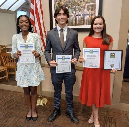 Three high school students holding cerfificates