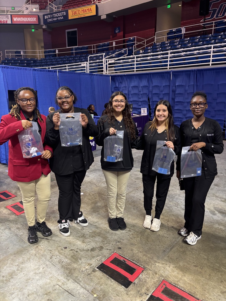 These students are showing off the bags they got from Infirmary Health.