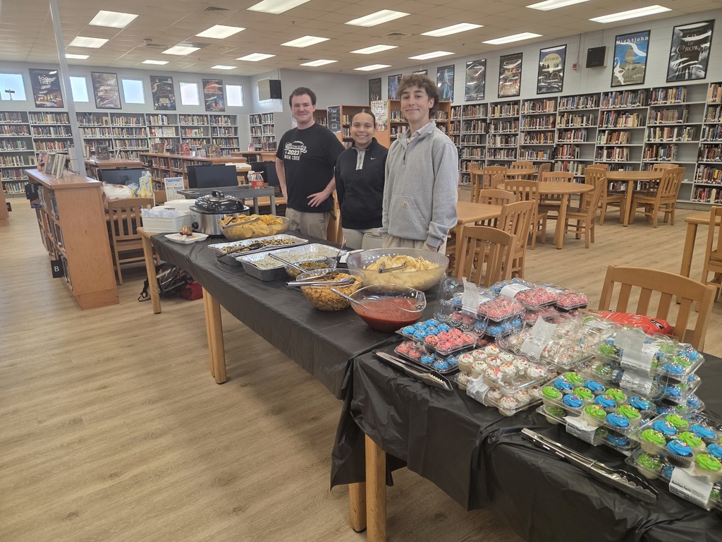 PTO officers in front of dips and cupcakes