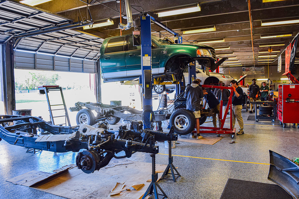 automotive students removing motor from frame