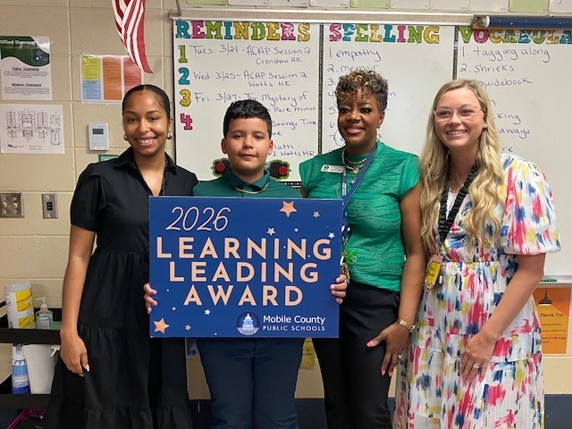 Rylan Besaw with his principal and teachers