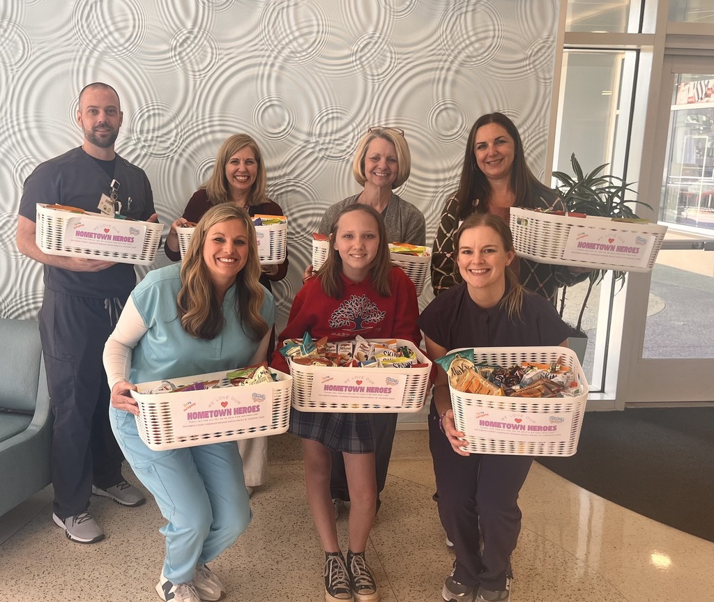 Nurses and a student holding baskets of snacks