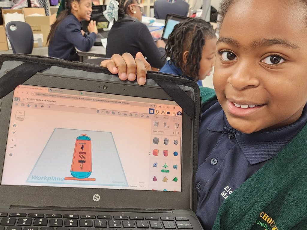 A student holds a laptop with a diagram of a cartouche  