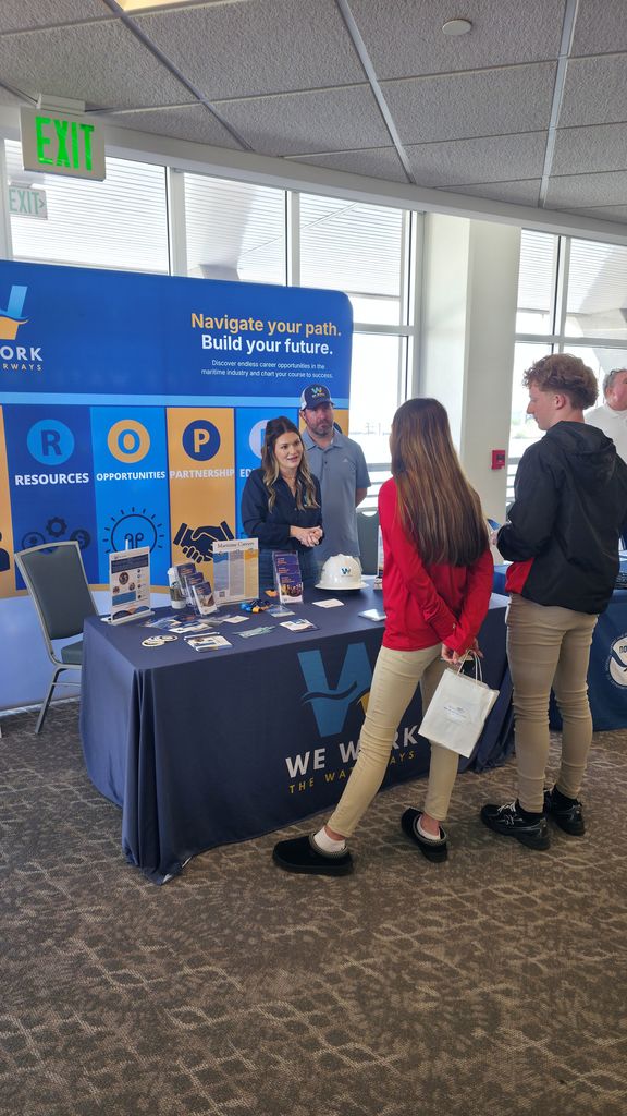 Students talking to representative from the Maritime Training Center.