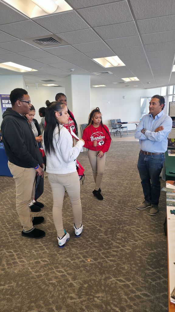 Students talking to representative from the Maritime Training Center.