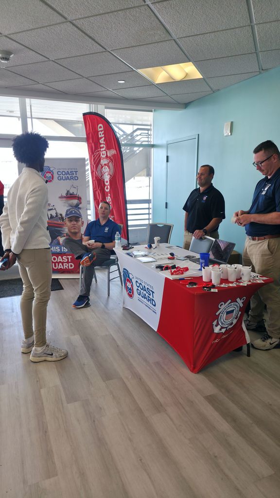 A student talking to representatives from the Coast Guard.