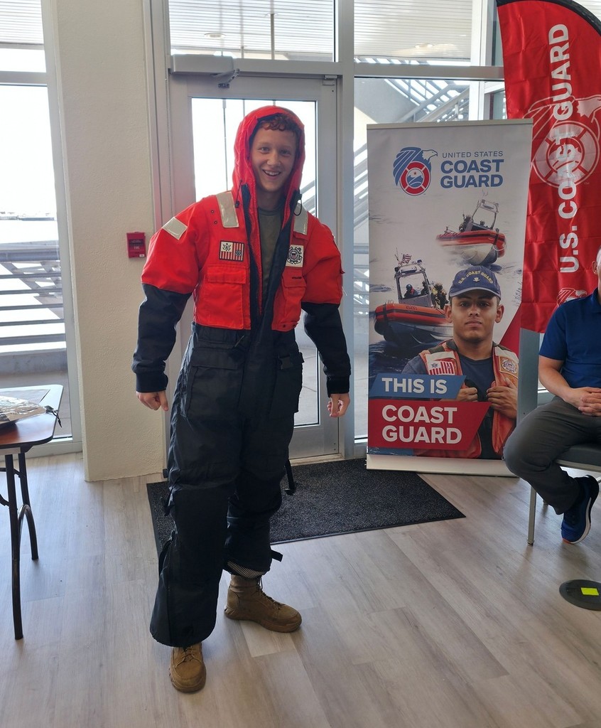 A high school student wearing a Coast Guard wetsuit