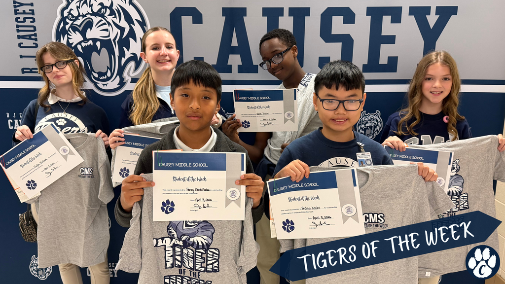 Students holding t-shirts and certificates, Tigers of the Week
