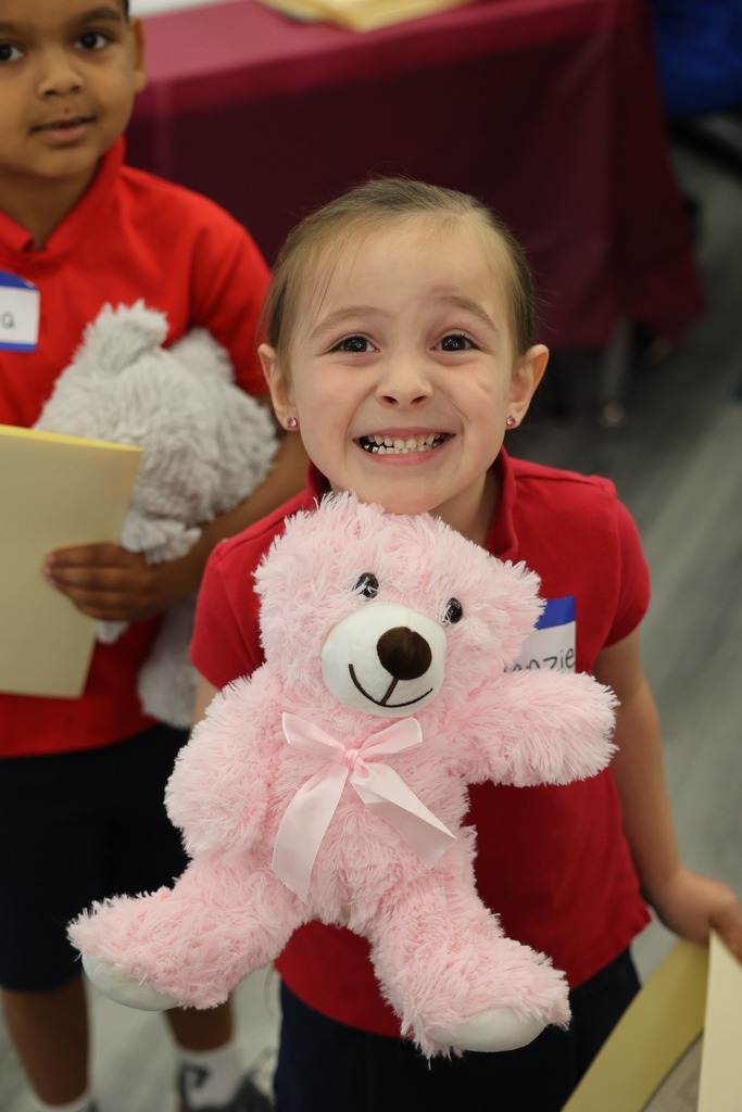 A Castlen Elementary student holding a teddy bear