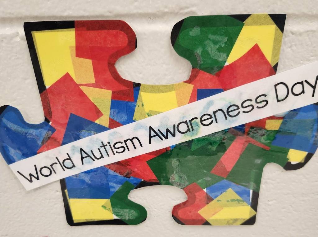 A large puzzle piece with the words "World Autism Awareness Day"
