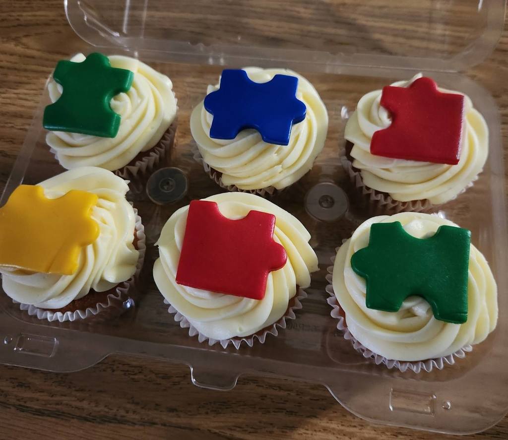 Cupcakes decorated with cutouts of puzzle pieces