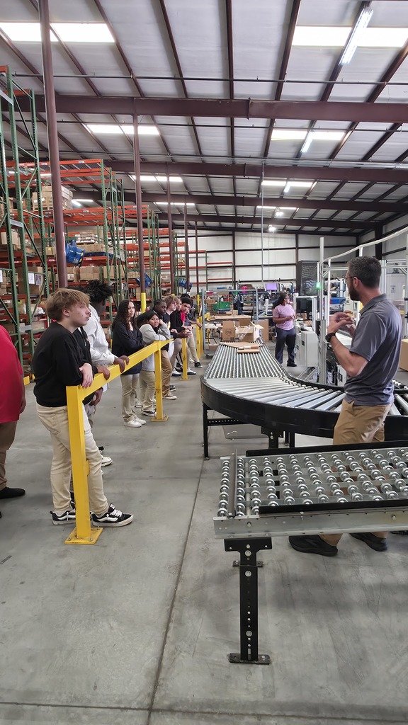 Students listening about package distribution on the Educators Resource field trip.