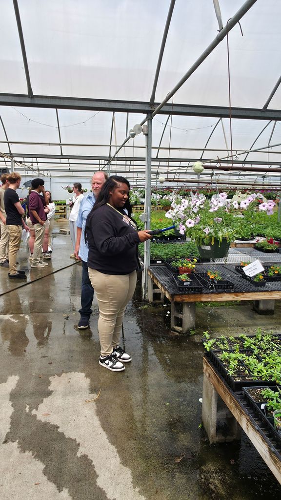 A group of students touring the greenhouse at the Bryant Center.