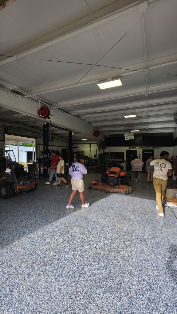 A group of students touring the small engine repair class.
