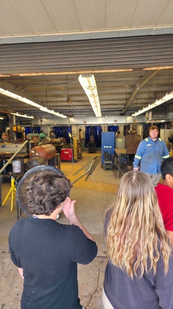 A group of students touring the mechanic class.