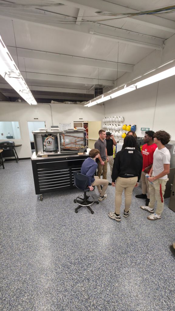 Another picture of the group touring the HVAC classroom.