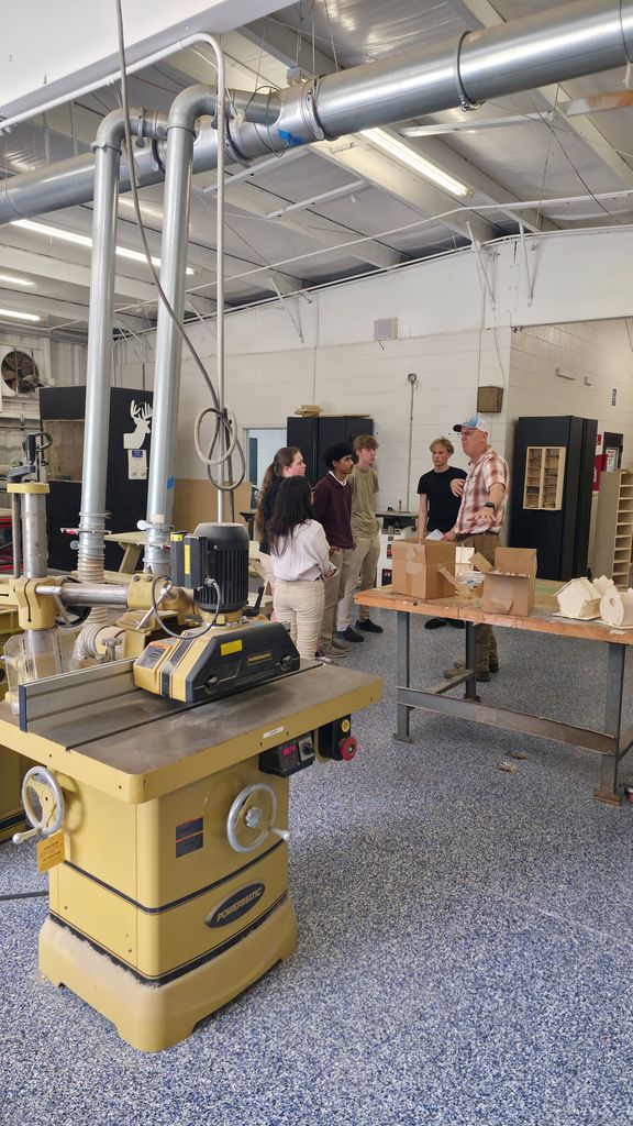 A group of students touring the carpentry workshop.