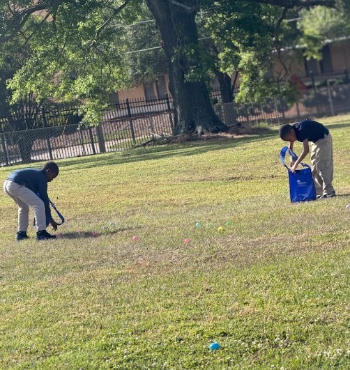 Students gathering eggs at an easter egg hunt 