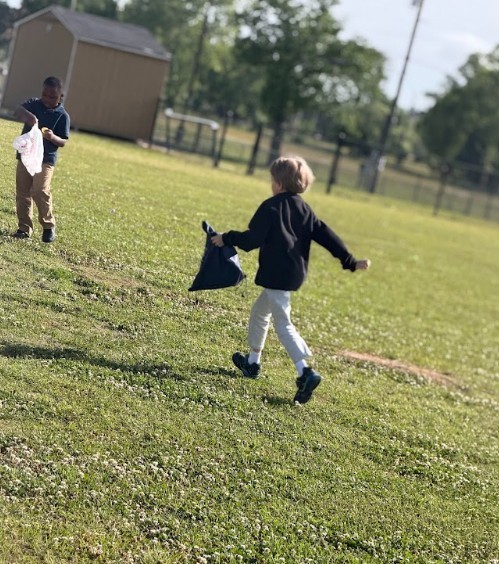 Students gathering eggs at an easter egg hunt 
