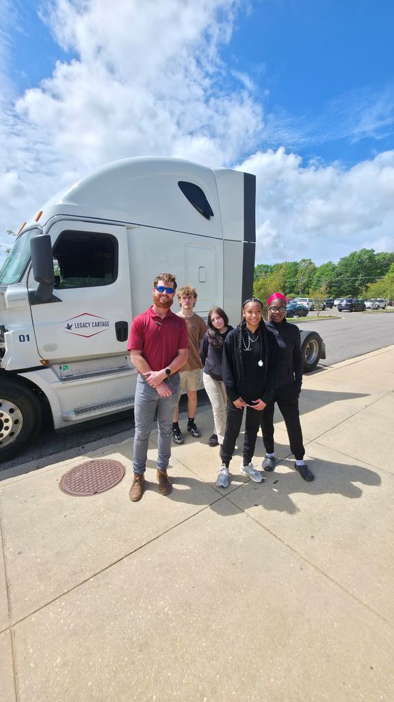 Students with the driver of the Legacy Cartage truck.