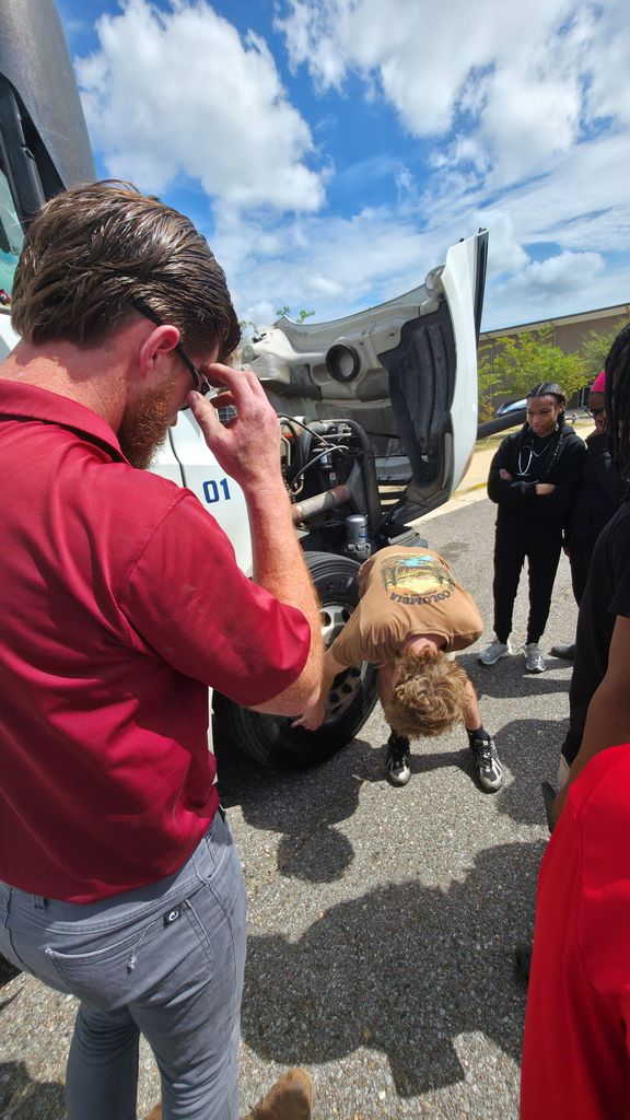 Inspecting the Legacy Cartage truck's tires.
